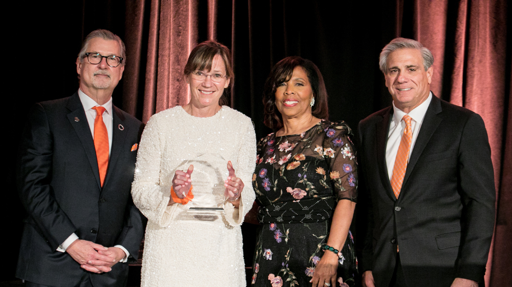 Four people including Dr. Mattix-Kramer holding an award